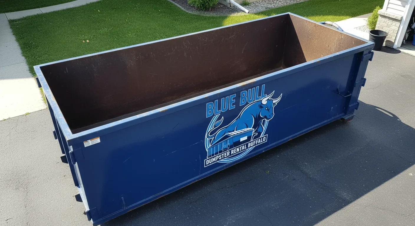 An empty Blue Bull dumpster, sized for smaller cleanouts, staged on a residential driveway in the Buffalo area